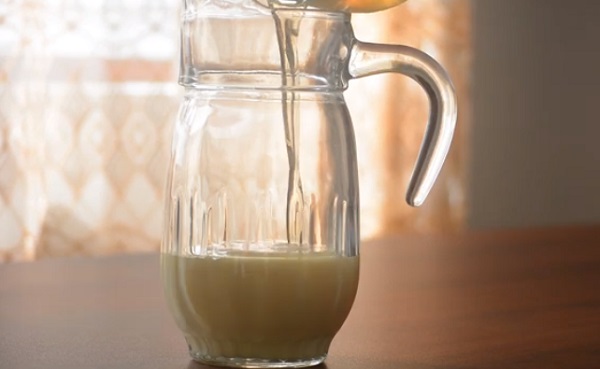 Добавление растворенного желатина в емкость со сгущенным молоком