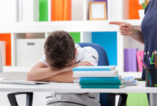 Мама ругает ребенка. Он лежит на столе, опустив голову вниз