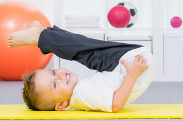 Мальчик занимается гимнастическими упражнениями