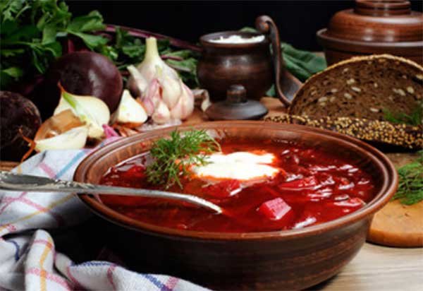 Глиняная тарелка с борщом.