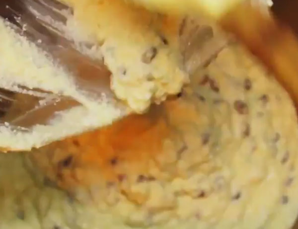 Из емкости в форму пересыпают тесто