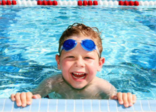 Счастливый мальчик в бассейне