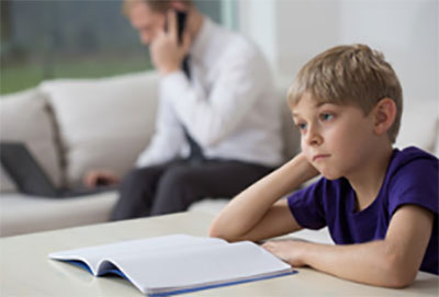 Ребенок сидит в задумчивости перед открытой тетрадью