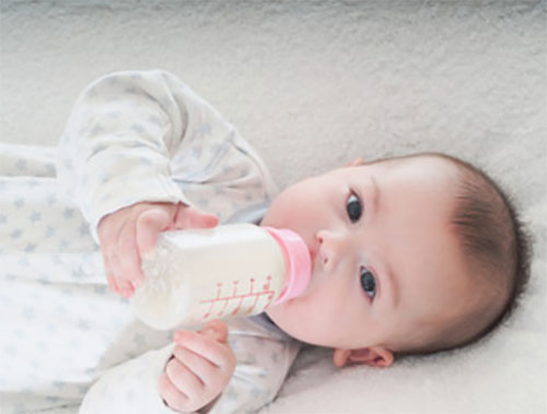 Грудничок пьет с бутылочки